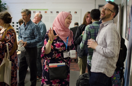 Lady in pink headscarf with laughing man at The British Islam Conference